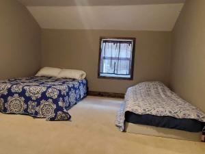 a bedroom with two beds and a window at Jeans Place in Northfork