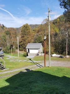 a house with a pole in the grass at Jeans Place in Northfork