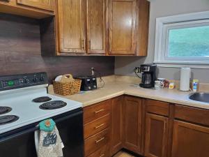a small kitchen with a stove and a sink at Jeans Place in Northfork +20 photos