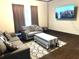 a living room with two couches and a tv at Jeans Place in Northfork