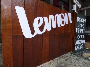 a sign for a restaurant on a wooden fence at Lemon Guesthouse in Ko Chang