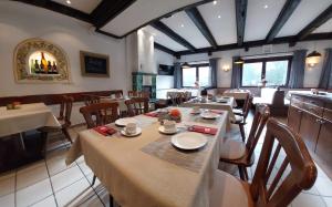 a dining room with tables and chairs in a restaurant at Draxlerhaus in Hohentauern