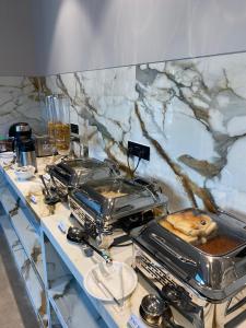 a table with a counter top with a food on it at J Hotel and Banquets in Mumbai