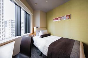 a hotel room with a bed and a large window at Tokyu Stay Kamata - Tokyo Haneda in Tokyo