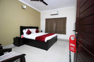 a bedroom with a bed and a red sign in it at Hotel Sai Leela in Puri