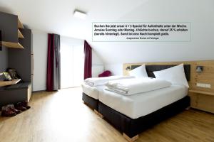 a bedroom with a large white bed in a room at K1 Hotel Willingen in Willingen