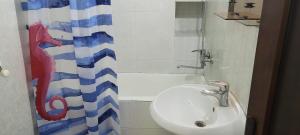 a bathroom with a sink and a shower curtain at Kiev hotel in Tbilisi City