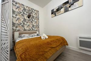 a bedroom with a bed with a brown blanket at El Castillo - Tournon sur Rhône in Tournon-sur-Rhône