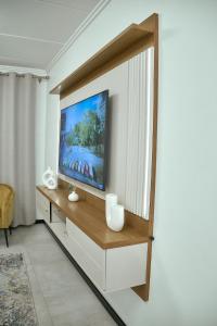 A television and/or entertainment centre at Medon Luxury Suites with power back up Bryanston Sandton