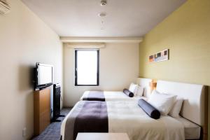 a hotel room with two beds and a tv at Tokyu Stay Kamata - Tokyo Haneda in Tokyo
