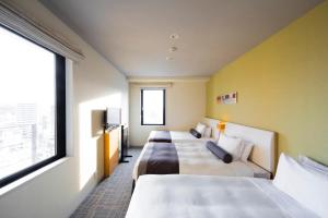 a hotel room with two beds and a window at Tokyu Stay Kamata - Tokyo Haneda in Tokyo
