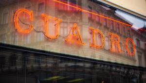 a neon sign on the side of a building at Schlossquadrat Apartement 14 A in Vienna