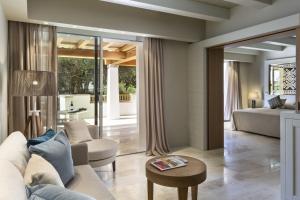 a living room with a couch and a table at Hotel La Bisaccia in Baja Sardinia