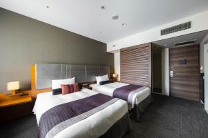 a hotel room with two beds in a room at Tokyu Stay Kamata - Tokyo Haneda in Tokyo