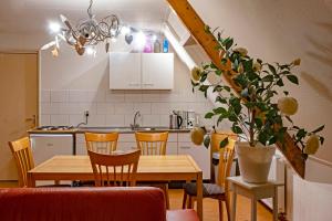 a kitchen with a wooden table and chairs and a dining room at opdehoekvandestal in Workum +49 photos
