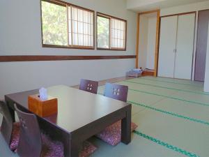 an empty room with a table and chairs in it at Marine Blue Yakushima in Yakushima