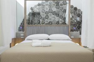 Postel nebo postele na pokoji v ubytování Lucente Rooms & Suites
