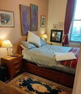 a bedroom with a bed and a table with a mirror at Whitby Central walk to Beach Pier Flowergate in Whitby