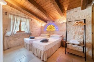 a bedroom with two beds in a room at Trullo Fantastico in Castellana Grotte