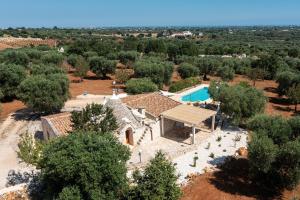 an aerial view of a house with a swimming pool at Trullo Fantastico in Castellana Grotte