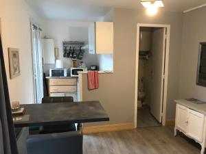 a kitchen with a table and a kitchen with a counter top at Studio le treport in Le Tréport