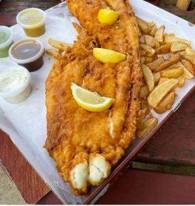 a plate of food with fish and french fries at Whitby Central walk to Beach Pier Flowergate in Whitby