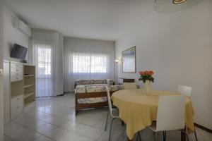 a living room with a table and a couch at Residence Il Patriarca in Viareggio