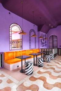 a restaurant with two tables and a couch at El Barrio Boutique Hotel & Bar in Canggu