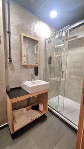 a bathroom with a sink and a shower at Art Hotel 158 in Sofia