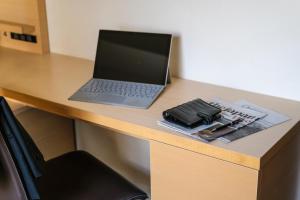a laptop computer sitting on top of a desk at Tokyu Stay Kamata - Tokyo Haneda in Tokyo