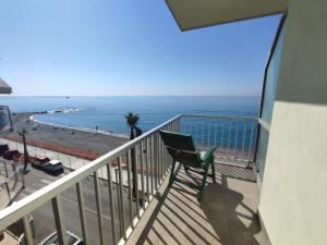 a balcony with a bench and the ocean at Appartamento ITACA - CITRA 08065-LT-0722 in Ventimiglia