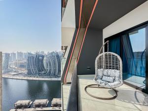 a chair on a balcony with a view of a city at Trophy - Luxury Casa Cielo Suites in Dubai