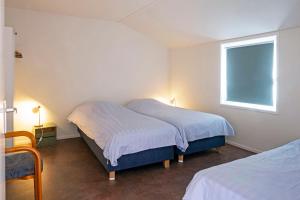 a bedroom with two beds and a window at opdehoekvandestal in Workum