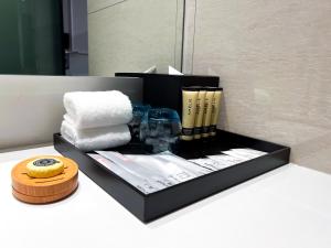 a black box with towels and other items on a counter at Hotel Royal Signature in Kuala Lumpur
