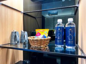 a table with bottles of water and a basket on it at Hotel Royal Signature in Kuala Lumpur