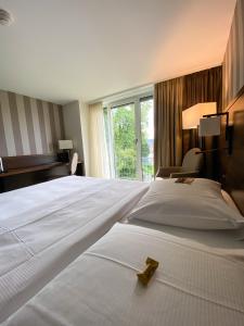 Katil atau katil-katil dalam bilik di Park Hotel Winterthur