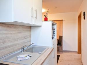 a kitchen with white cabinets and a sink at Kalbe Milde, Ferienwohnung Altmark in Kalbe