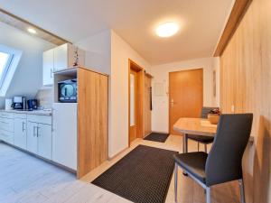 a kitchen and dining room with a table and a refrigerator at Kalbe Milde, Ferienwohnung Altmark in Kalbe