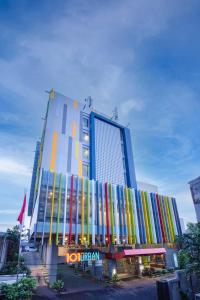 a hotel with a building with colorful facade at 1O1 URBAN Jakarta Pemuda in Jakarta
