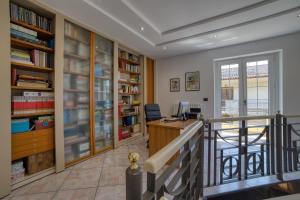 ein Heimbüro mit einem Schreibtisch und Bücherregalen in der Unterkunft Villa Alba in Petacciato