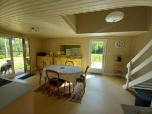 a dining room with a table and chairs in a room at Le Chalet Limousin in Folles