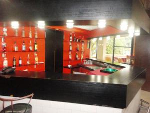 a kitchen with red cabinets and a black counter top at Hôtel Source Du Nil in Bujumbura