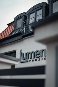 a sign on the side of a building at Lumen Gasztropanzió in Eger