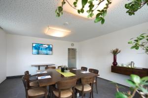 a dining room with a table and chairs at Hotel Staffler in Odelzhausen