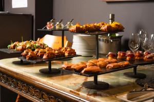 a buffet with many different types of food on display at Hotel Atari in Donostia-San Sebastián
