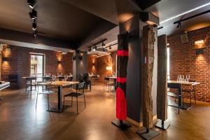 a restaurant with tables and chairs and brick walls at Hotel Atari in Donostia-San Sebastián