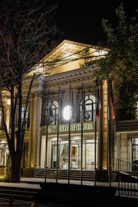 a building lit up at night at WELLFORT HOTEL in Samarkand