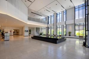 a large lobby with a large building with windows at Anya Hotel Quy Nhon in Quy Nhon