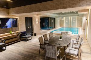 a living room with a table and a swimming pool at WELLFORT HOTEL in Samarkand