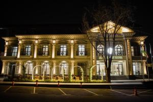 a building lit up at night at WELLFORT HOTEL in Samarkand